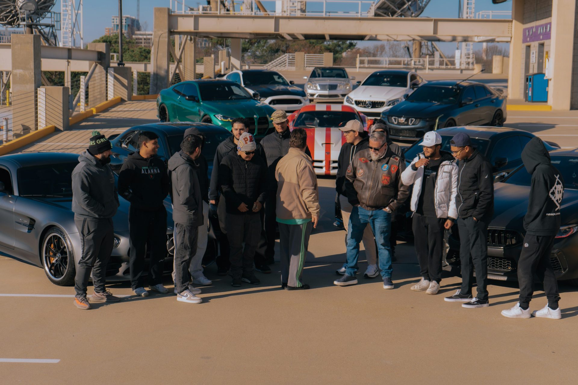 A group of people standing in a parking lot