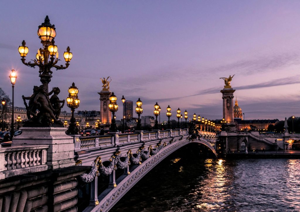 The Pont Alexandre III bridge illuminated at night in Paris, France